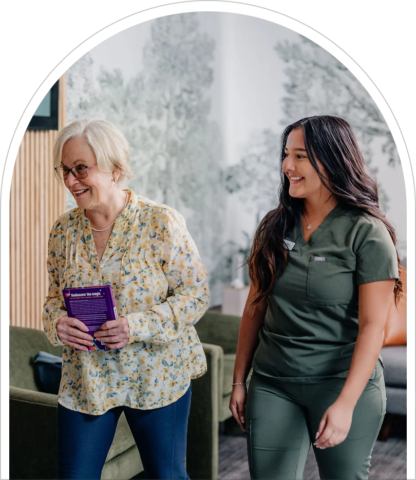An Enamyl Dentistry team member warmly guiding a patient through the office