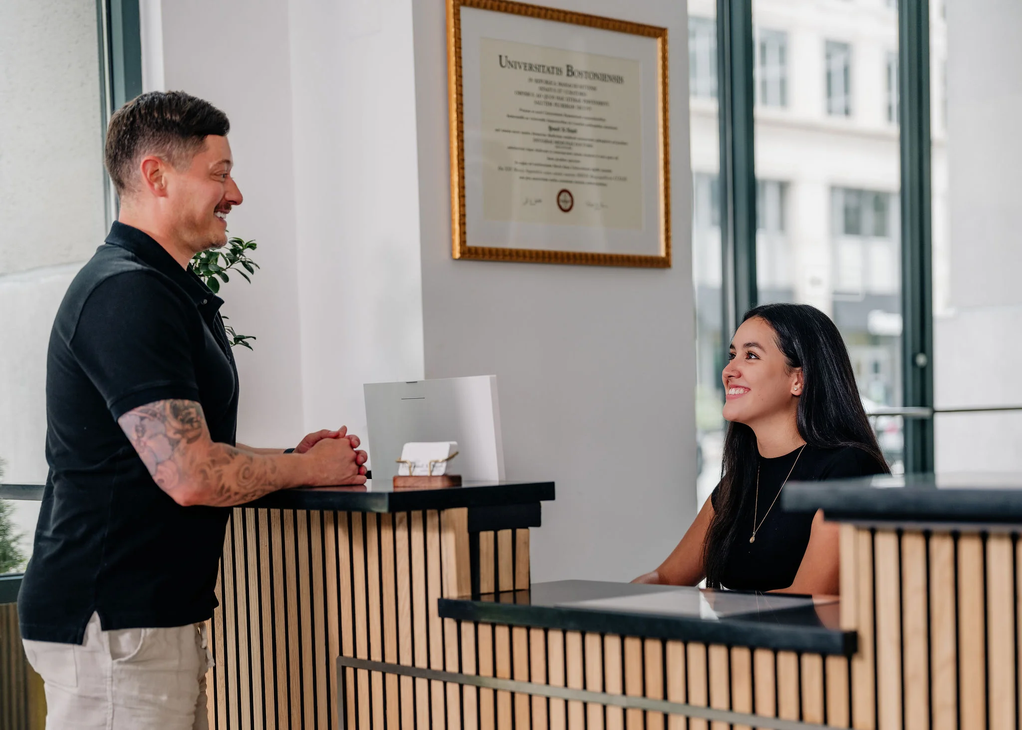 A new patient checking in at the Enamyl Dentistry front desk in Ballston, Arlington